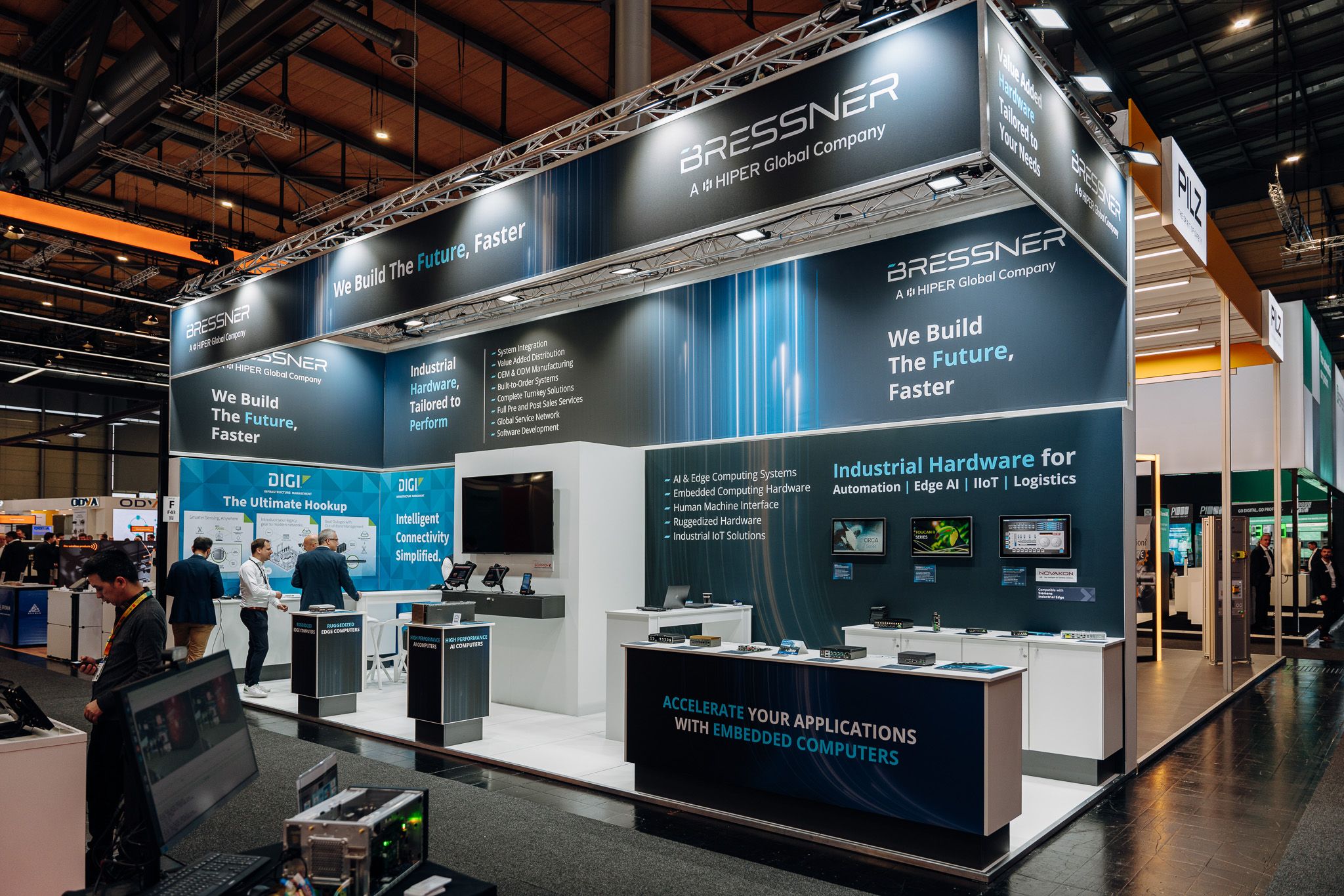 Messestand von BRESSNER Technology auf der Hannover Messe 2026 mit dem Claim 'We Build The Future, Faster' und Fokus auf Industrial Hardware für Automation, Edge AI, IIoT und Logistik.